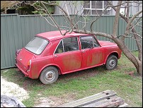 Morris 1100 beside house